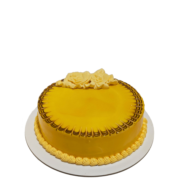 Round mango-flavored cake with yellow glaze and piped roses on top