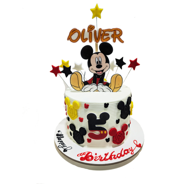 Mickey Mouse-themed birthday cake with fondant Mickey faces, red and yellow star toppers, and “Oliver” name topper.