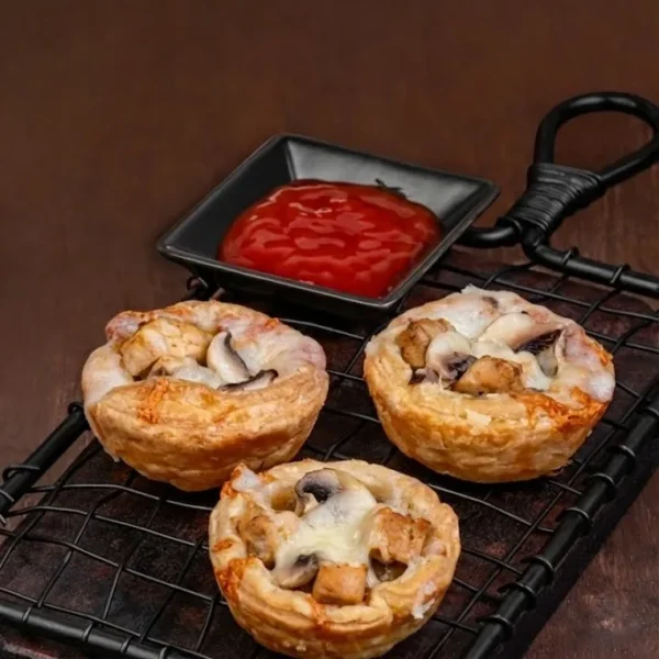 Chicken Mushroom pie Chicken mushroom pies in flaky pastry with melted topping, served with ketchup dip.