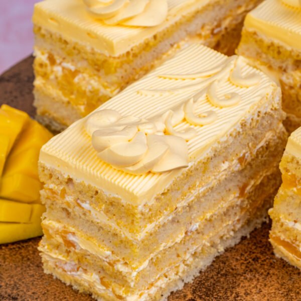 Mango pastry slice with layered vanilla sponge and mango cream frosting