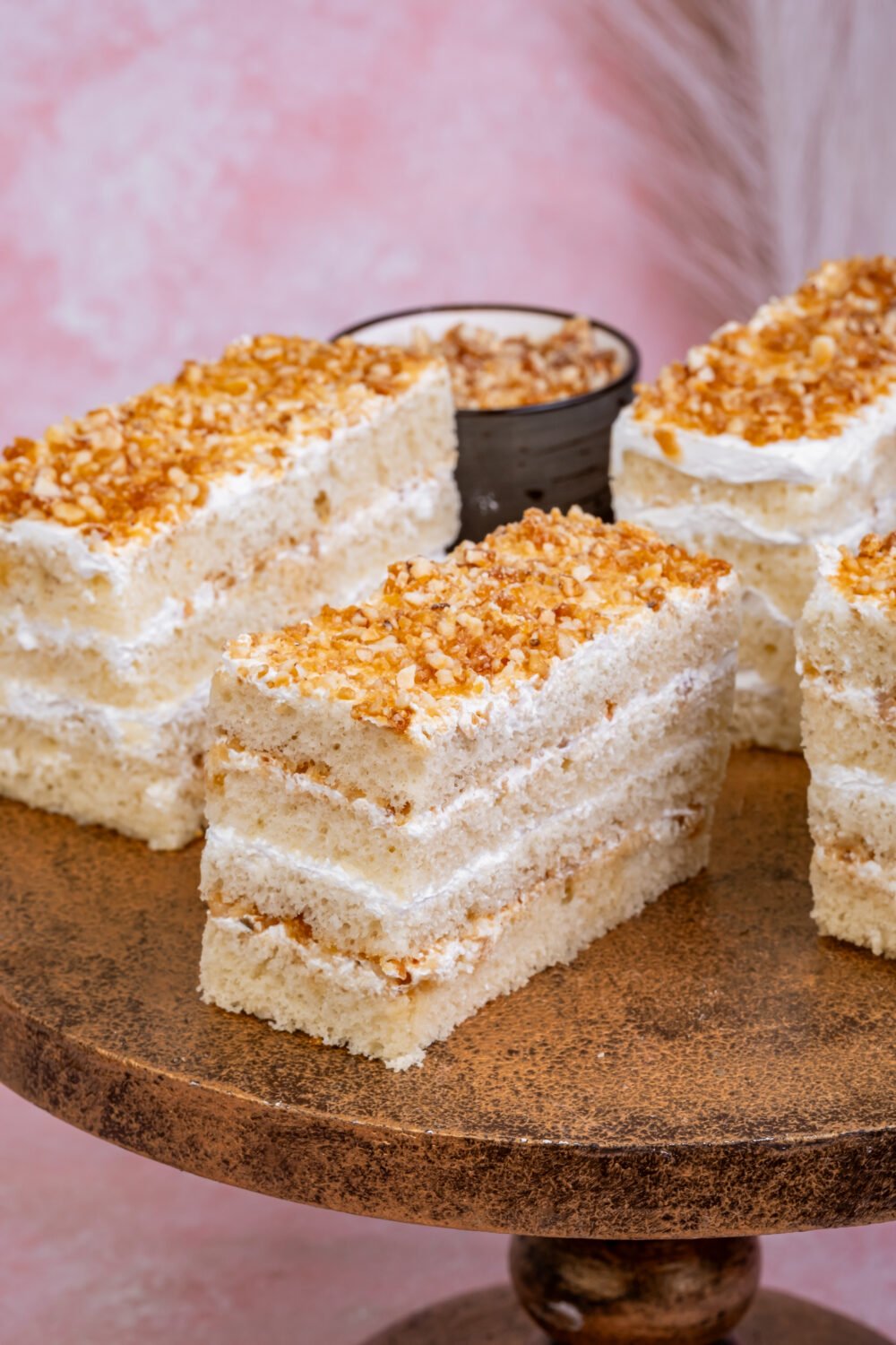 Nougat Pastry Nougat pastry slice with vanilla sponge, cream layers, and crunchy butterscotch nougat topping
