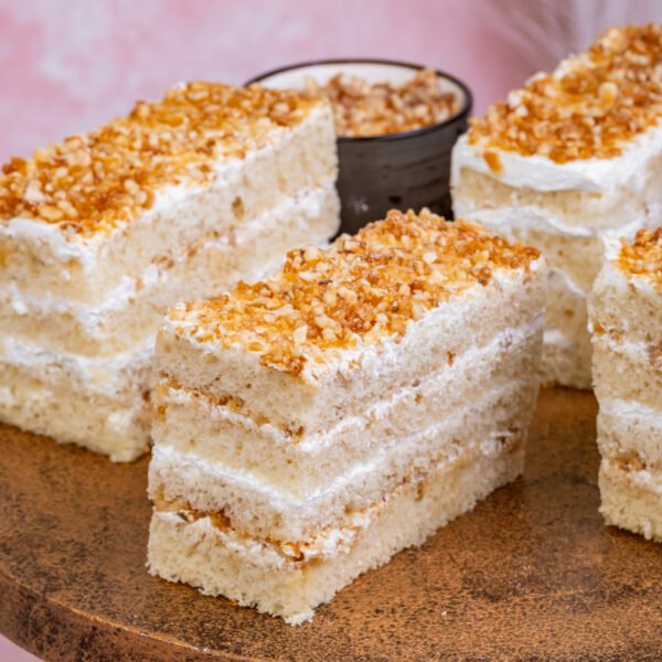 Nougat Pastry Nougat pastry slice with vanilla sponge, cream layers, and crunchy butterscotch nougat topping
